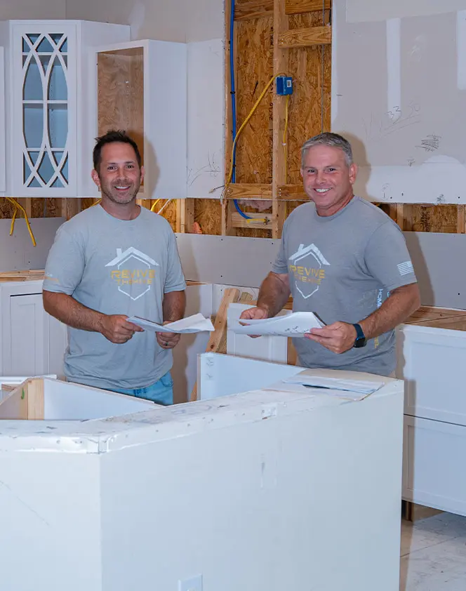 2 smiling men in a deconstructed kitchen